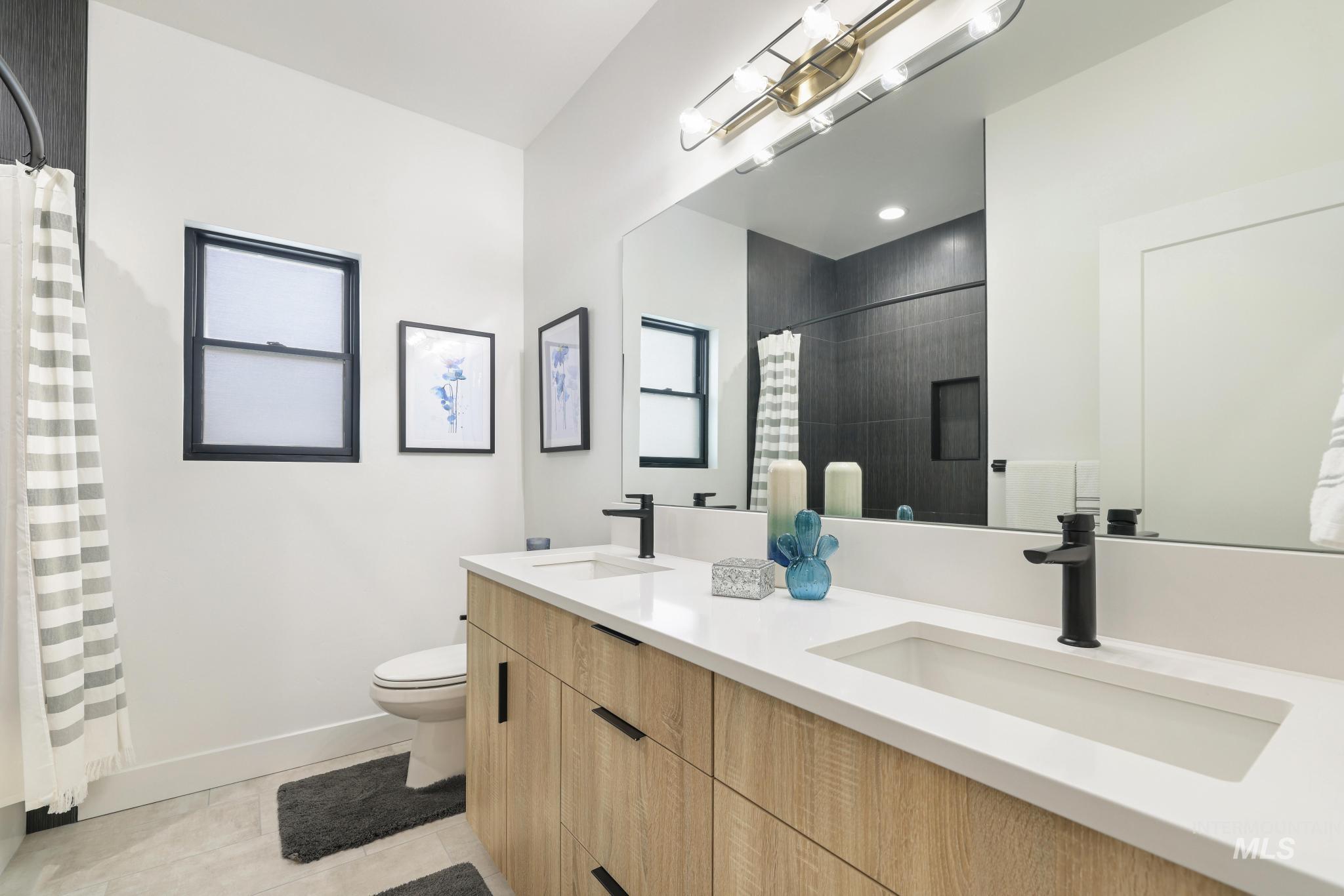 3140 Moonrise Road Twin Falls, ID 83301 - Photo 31 of 39 Bathroom featuring double vanity, a shower with shower curtain, and light tile patterned flooring