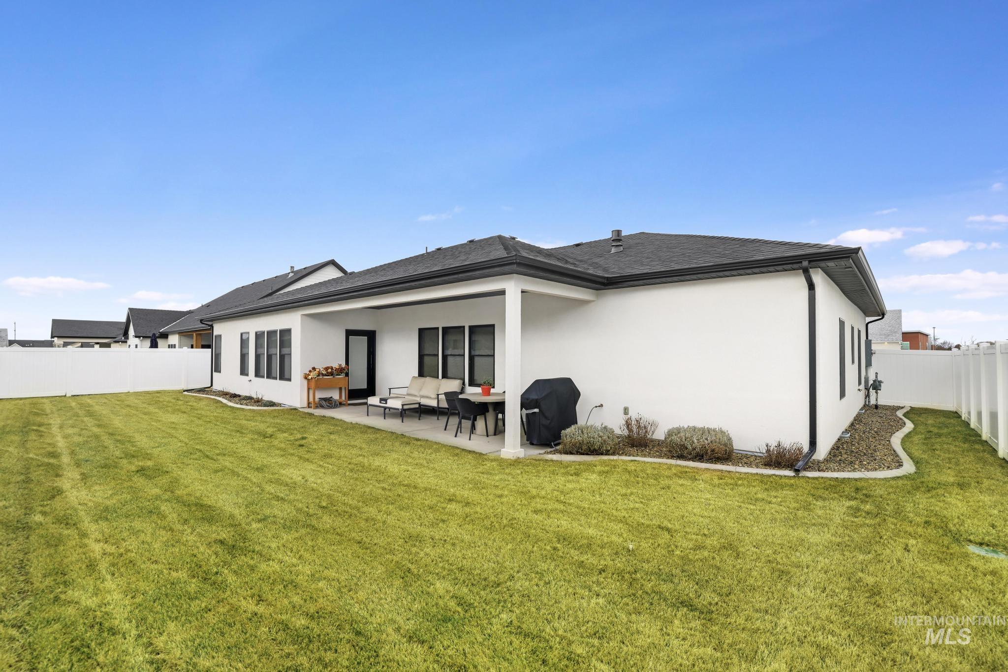 3140 Moonrise Road Twin Falls, ID 83301 - Photo 37 of 39 Back of property featuring a fenced backyard, stucco siding, and a patio area