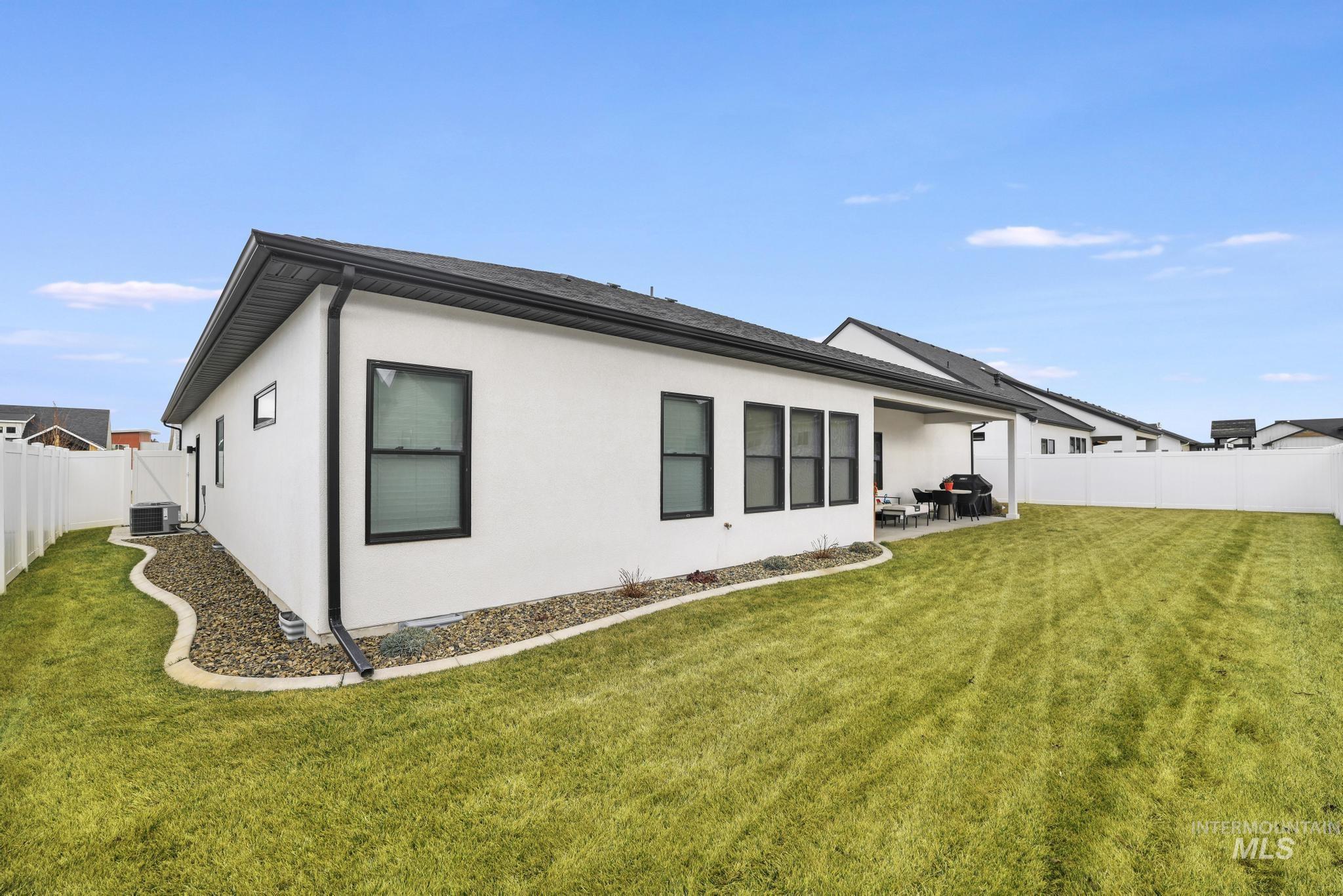 3140 Moonrise Road Twin Falls, ID 83301 - Photo 38 of 39 Rear view of house featuring a fenced backyard, stucco siding, and a patio
