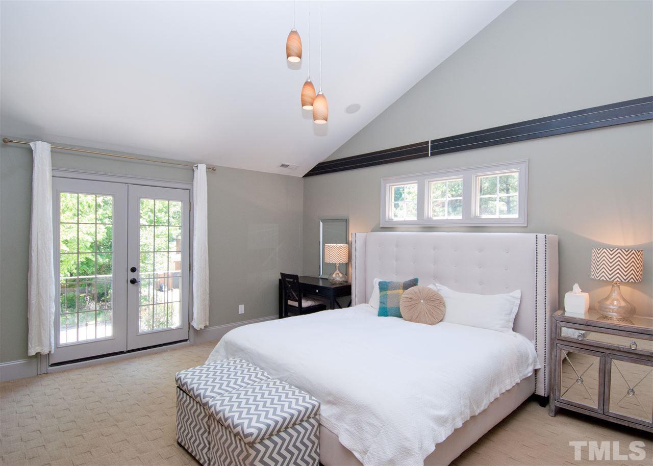 520 Smokeridge Lane Raleigh, NC 27615 - Photo 11 of 25 a bedroom with a large bed and a large window