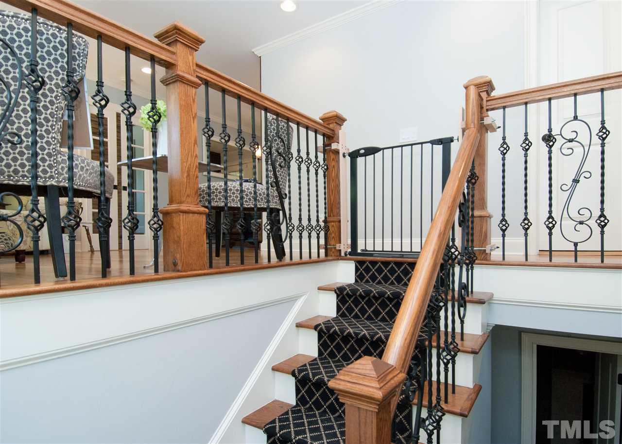 520 Smokeridge Lane Raleigh, NC 27615 - Photo 5 of 25 a view of staircase with lots of frames on wall and a window