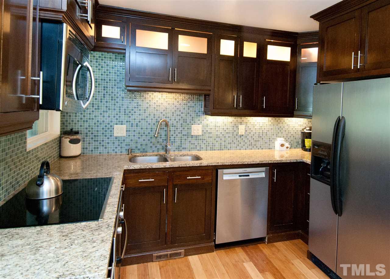 520 Smokeridge Lane Raleigh, NC 27615 - Photo 8 of 25 a kitchen with stainless steel appliances granite countertop a sink stove and cabinets