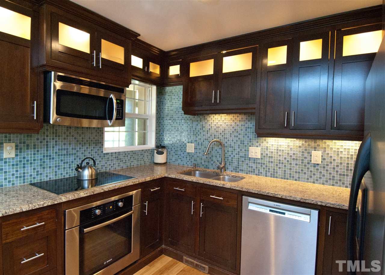 520 Smokeridge Lane Raleigh, NC 27615 - Photo 9 of 25 a kitchen with granite countertop a sink stainless steel appliances and cabinets