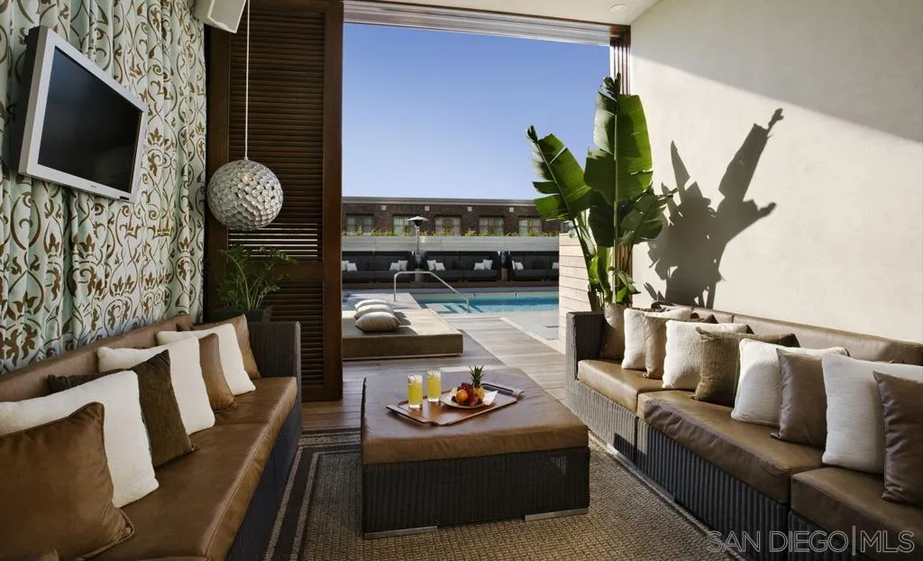 207 Fifth Avenue, Unit 737 San Diego, CA 92101 - Photo 6 of 14 a living room with furniture and a flat screen tv