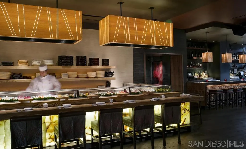 207 Fifth Avenue, Unit 737 San Diego, CA 92101 - Photo 9 of 14 a kitchen with stainless steel appliances granite countertop a stove and cabinets