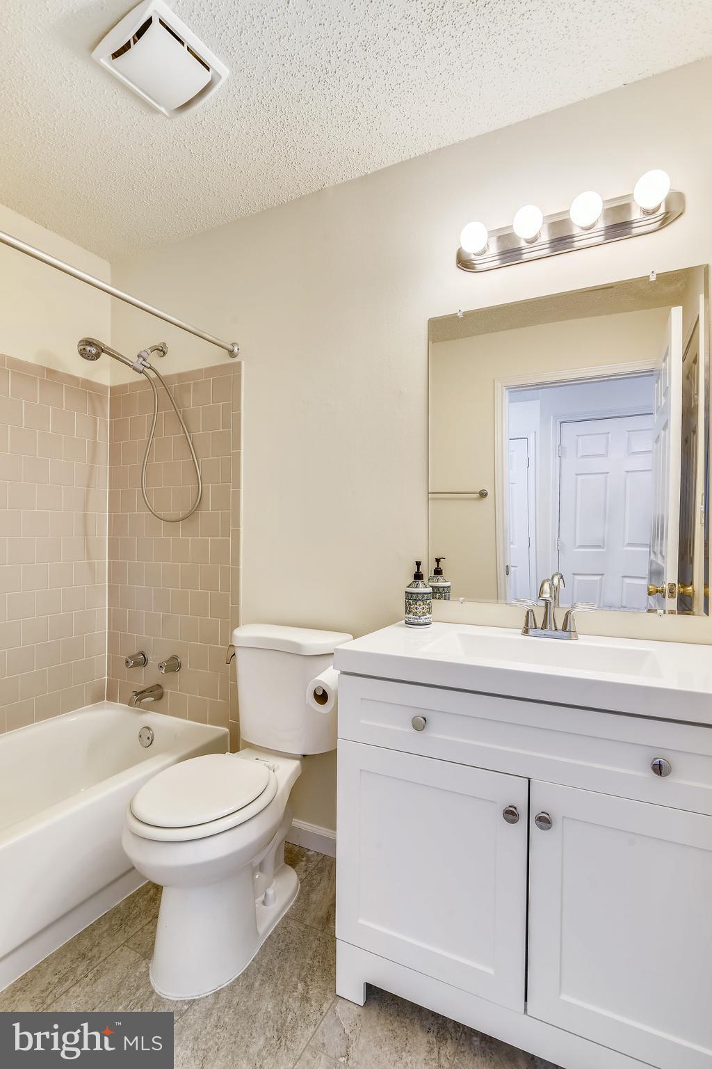 21023 Timber Ridge Terrace, Unit 302 Ashburn, VA 20147 - Photo 5 of 16 New vanity, flooring and fixtures.