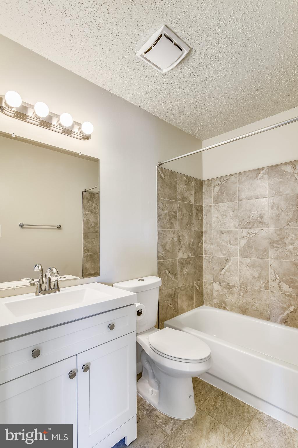 21023 Timber Ridge Terrace, Unit 302 Ashburn, VA 20147 - Photo 7 of 16 MBath features new vanity, flooring and fixtures.