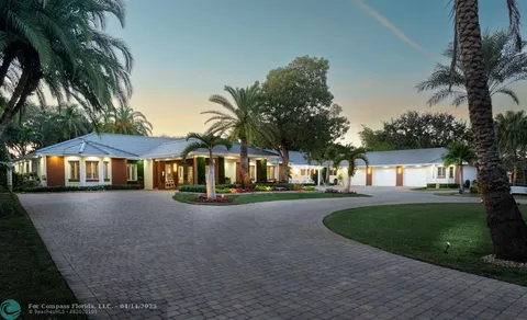 a view of a house with a yard and tree s