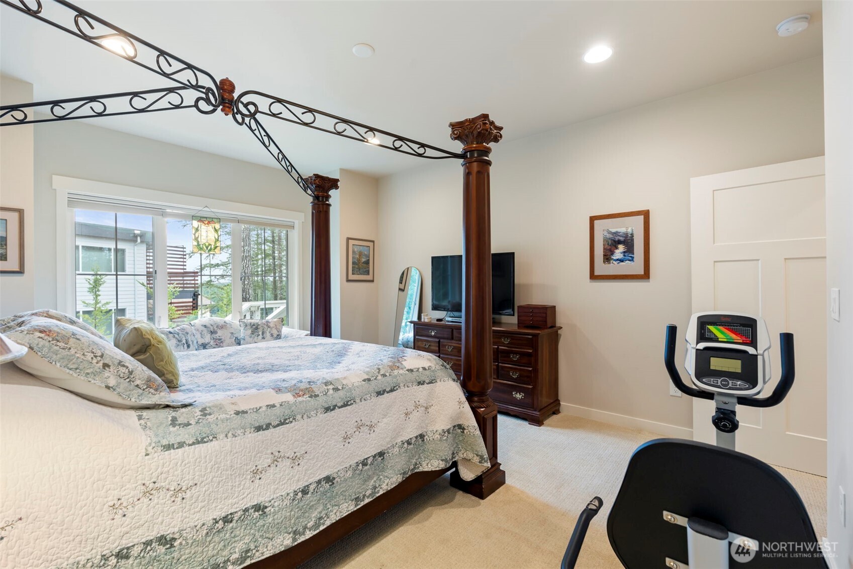 71 East Hemlock Court Union, WA 98592 - Photo 14 of 32 a bedroom with a bed next to a window and a flat screen tv