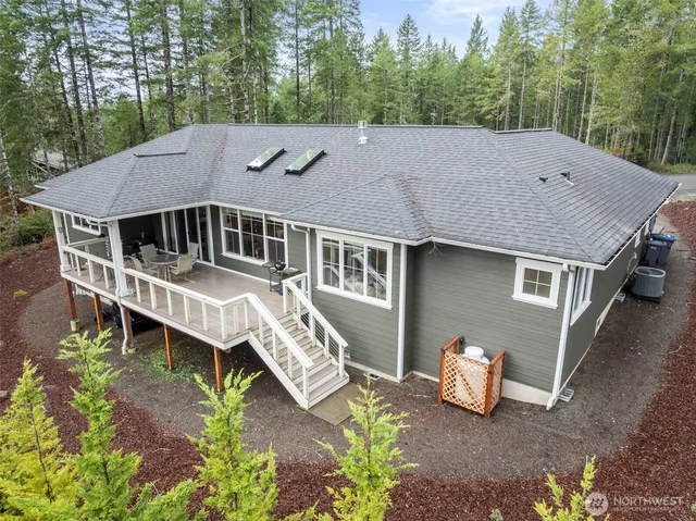 a aerial view of a house with roof deck and outdoor seating