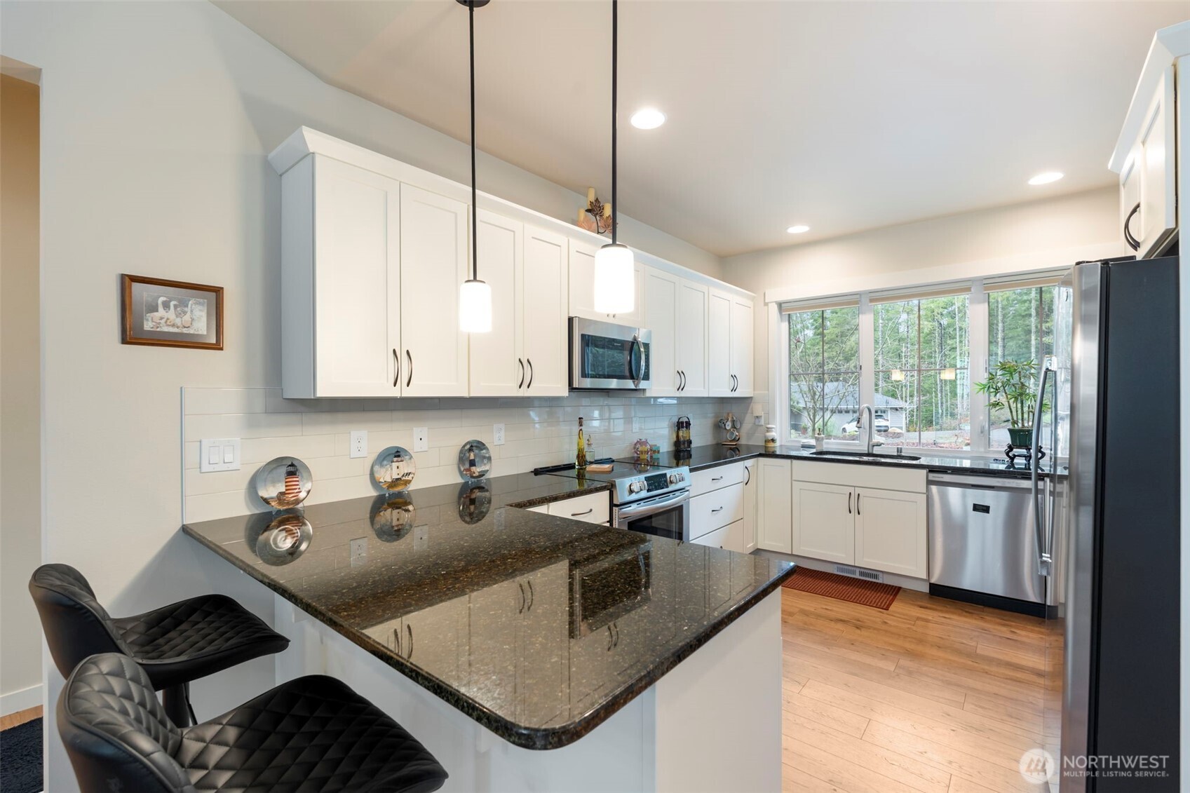 71 East Hemlock Court Union, WA 98592 - Photo 7 of 32 a kitchen with stainless steel appliances granite countertop a sink stove and cabinets