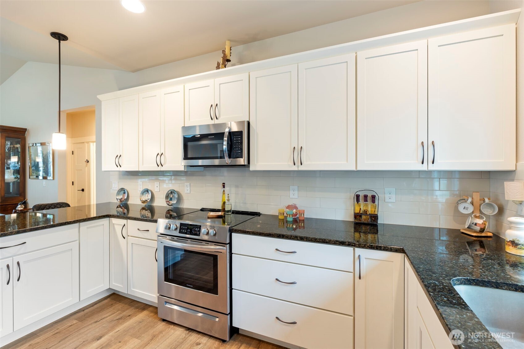 71 East Hemlock Court Union, WA 98592 - Photo 9 of 32 a kitchen with stainless steel appliances granite countertop white cabinets sink and stove