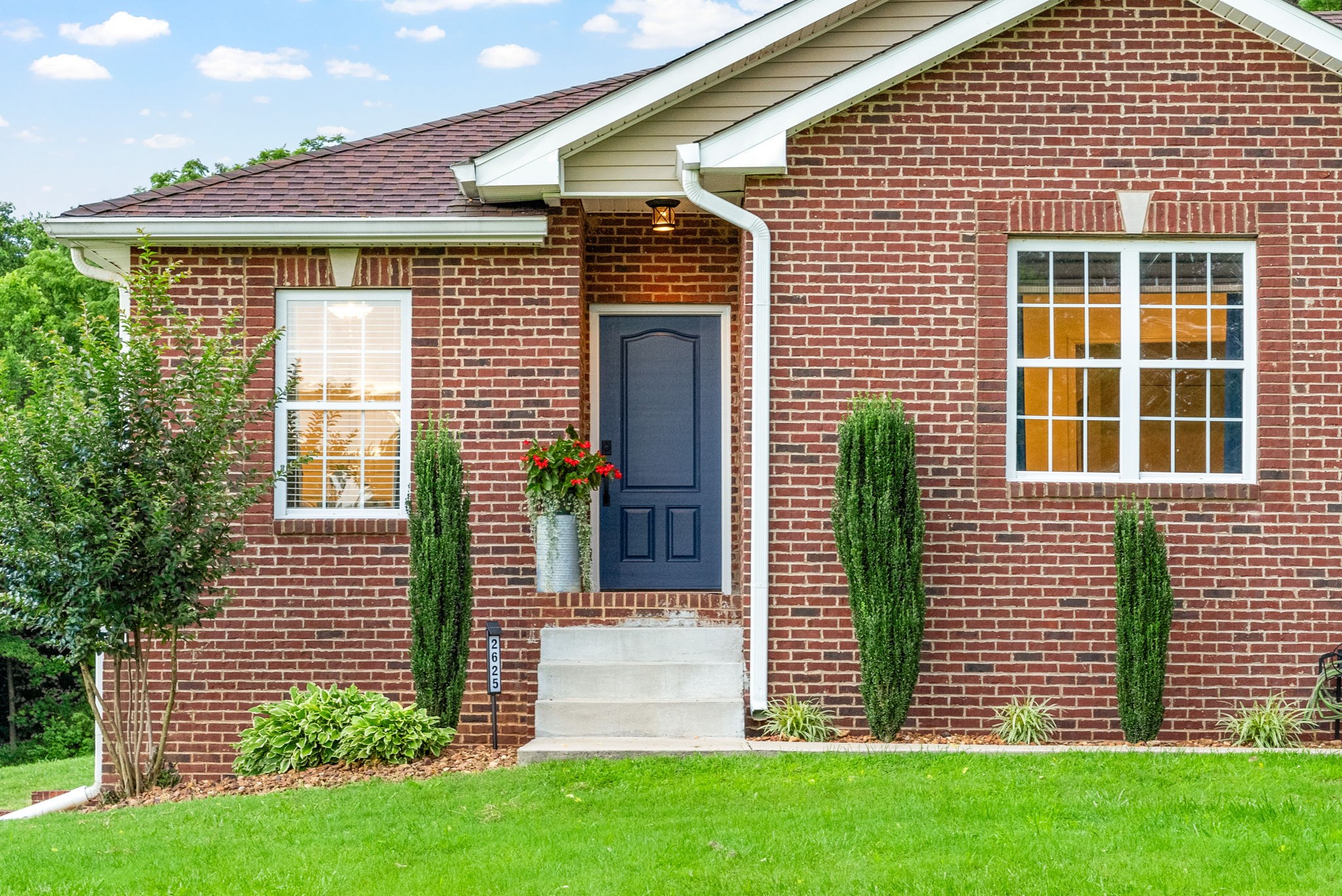 2625 Ford Road Adams, TN 37010 - Photo 5 of 34 a front view of a house with a garden