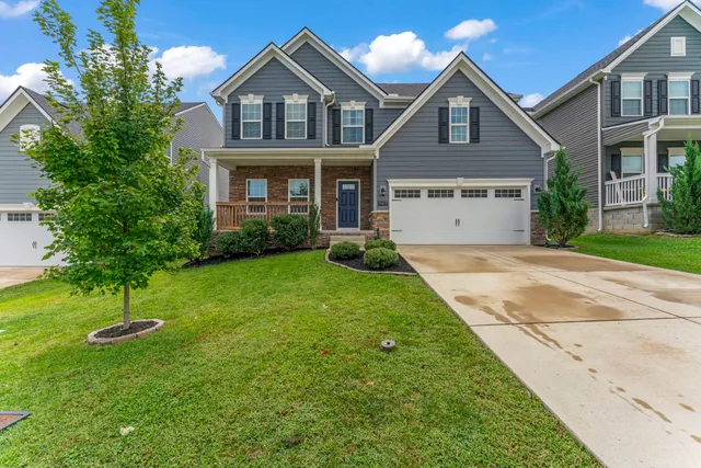a front view of a house with a yard and garage