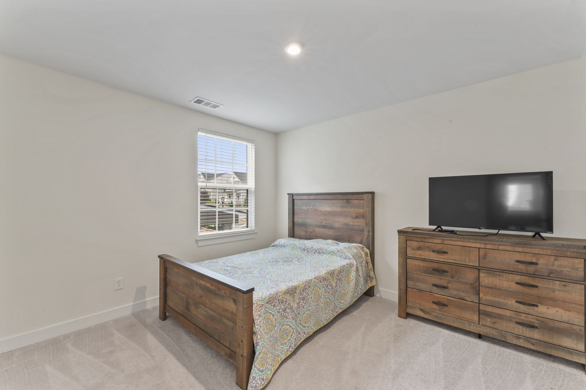 907 Caywood Road Smyrna, TN 37167 - Photo 20 of 32 a bedroom with a bed and a flat screen tv