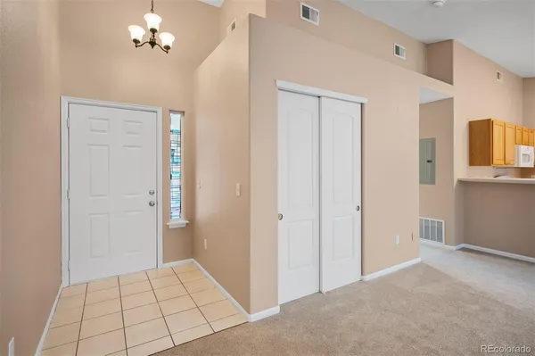 a view of a chandelier fan and entryway