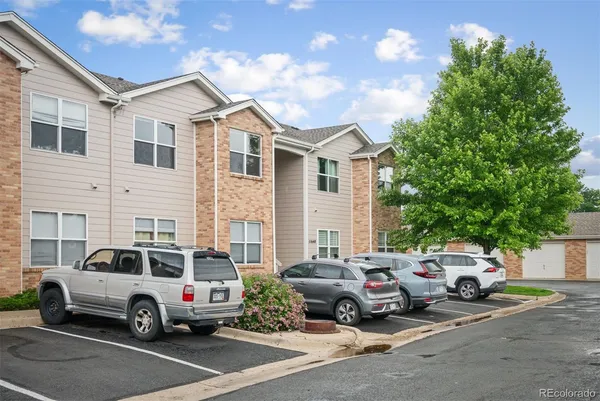 a view of a cars park in front of a house