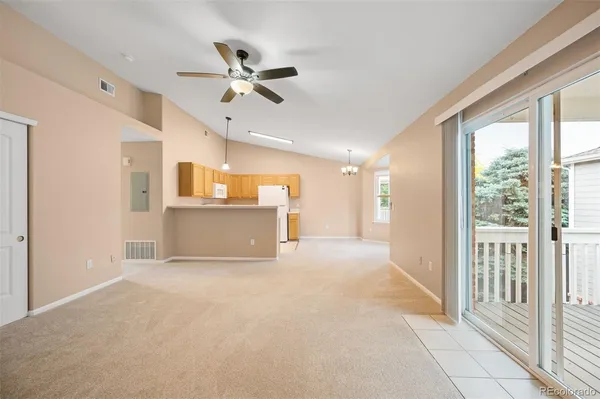 a view of a livingroom with a ceiling fan and window