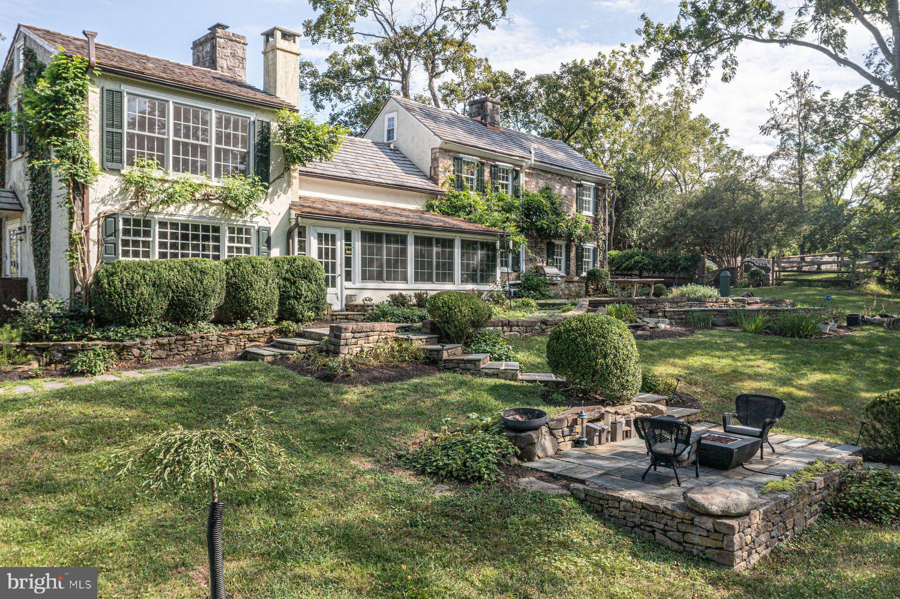 a front view of a house with garden and outdoor seating