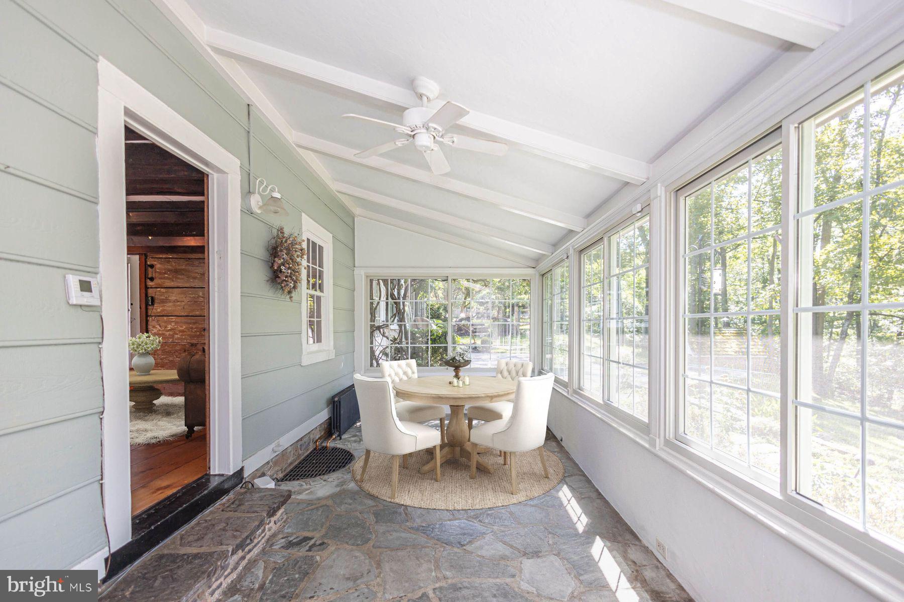 5925 Carversville Road Doylestown, PA 18902 - Photo 11 of 44 a dining room with wooden floor and a floor to ceiling window