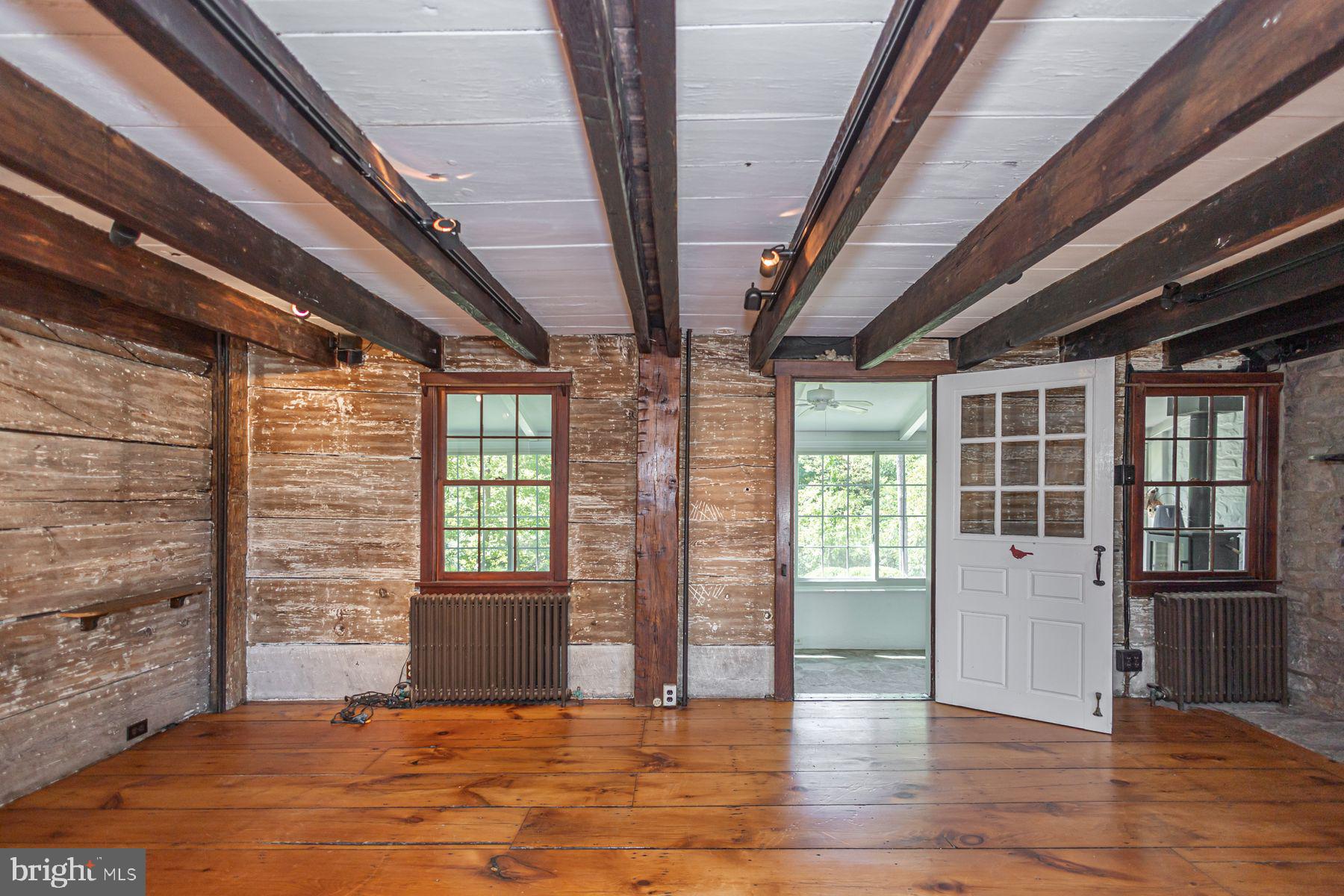 5925 Carversville Road Doylestown, PA 18902 - Photo 14 of 44 a view of an empty room with wooden floor and a window