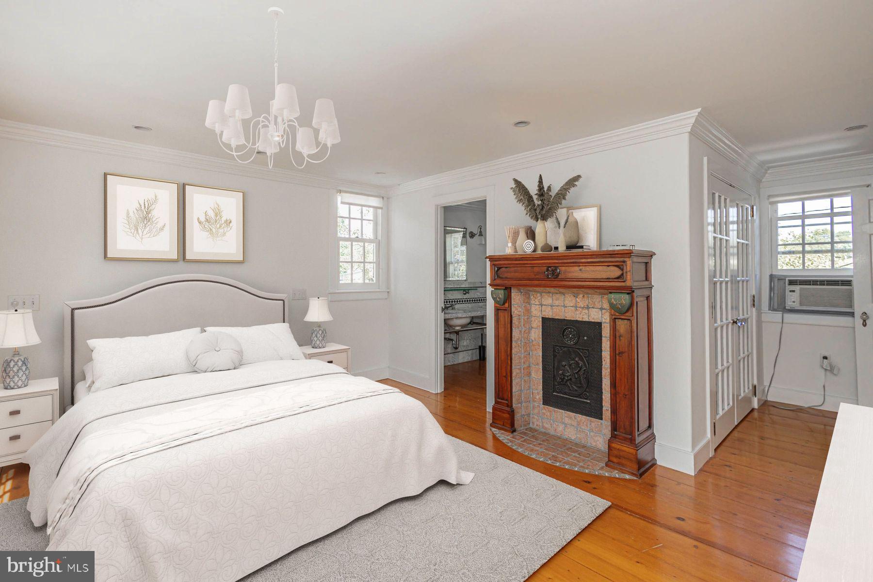 5925 Carversville Road Doylestown, PA 18902 - Photo 20 of 44 a bedroom with a large bed and a chandelier