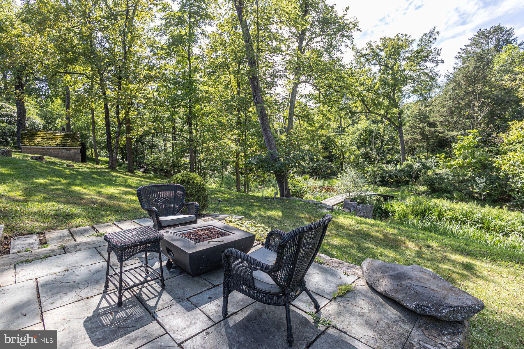 5925 Carversville Road Doylestown, PA 18902 - Photo 28 of 44 a backyard of a house with yard table and chairs