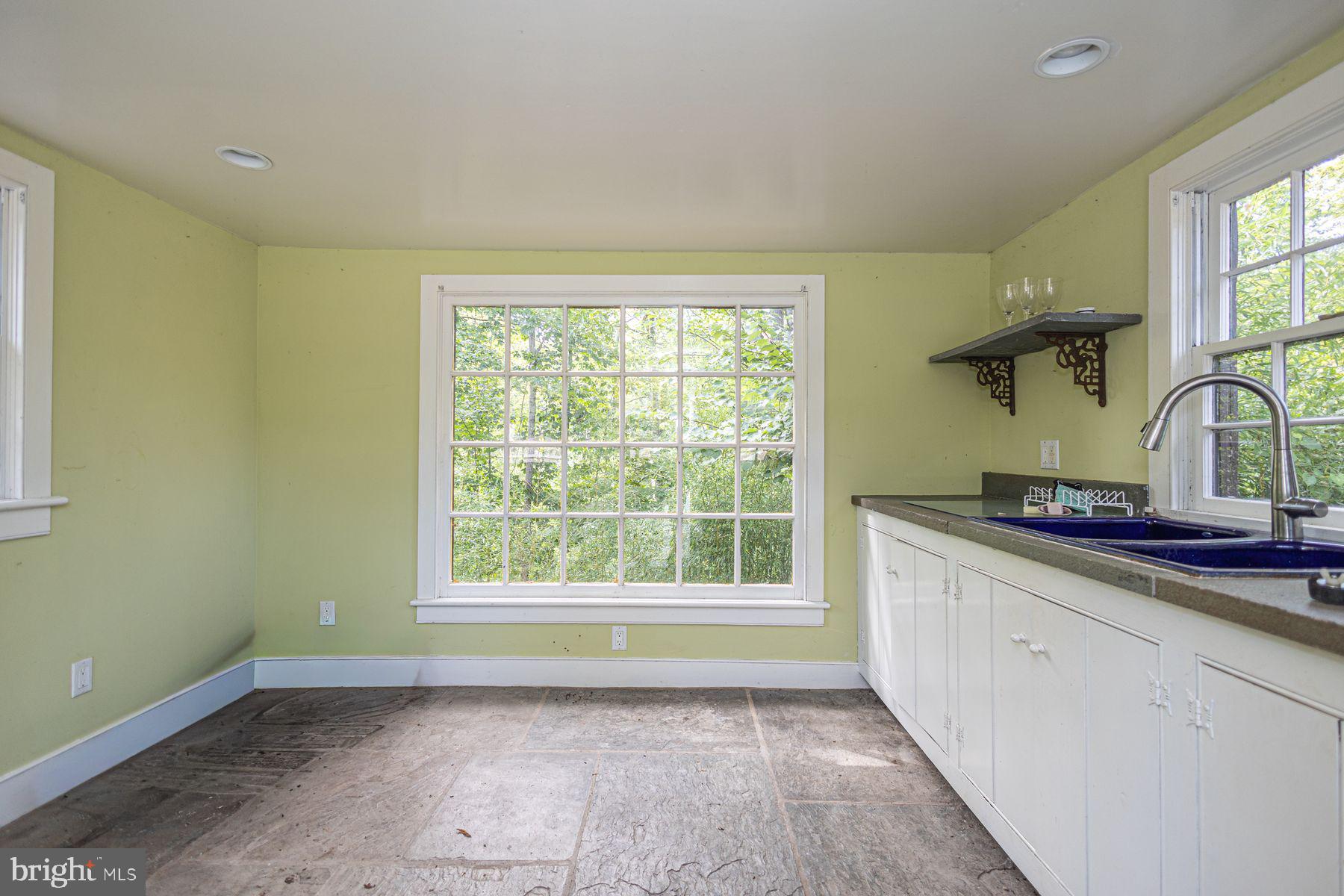 5925 Carversville Road Doylestown, PA 18902 - Photo 35 of 44 a view of a kitchen with a sink wooden cabinets and a window
