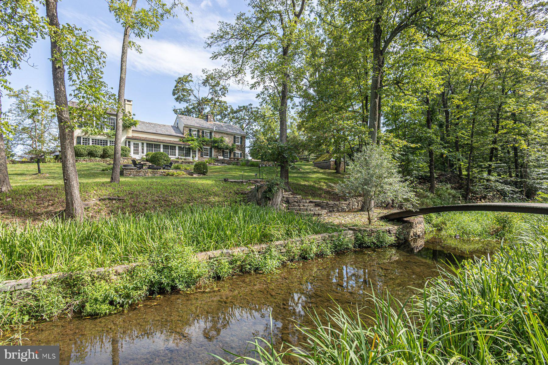 5925 Carversville Road Doylestown, PA 18902 - Photo 43 of 44 a view of a garden with plants and a lake view