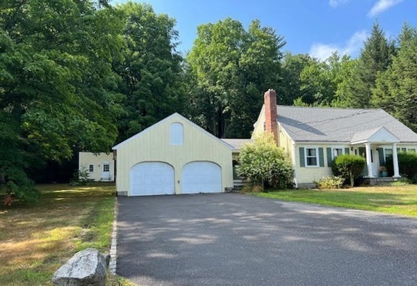 288 Sugar Road Bolton, MA 01740 - Photo 12 of 13 a front view of a house with garden