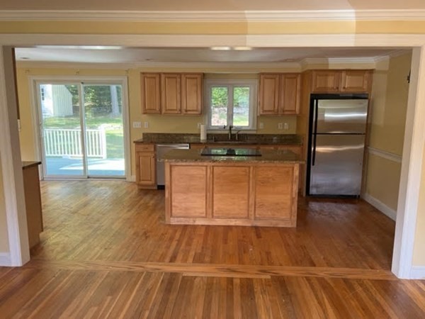 288 Sugar Road Bolton, MA 01740 - Photo 3 of 13 a kitchen with granite countertop a stove and refrigerator