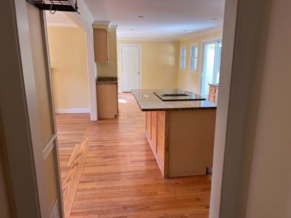 288 Sugar Road Bolton, MA 01740 - Photo 6 of 13 a view of a hallway with wooden floor and staircase