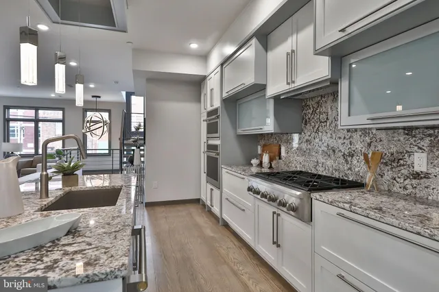 a living room with furniture a couch and a flat screen tv