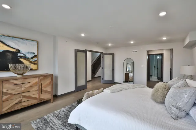 a bedroom with a bed and a mirror