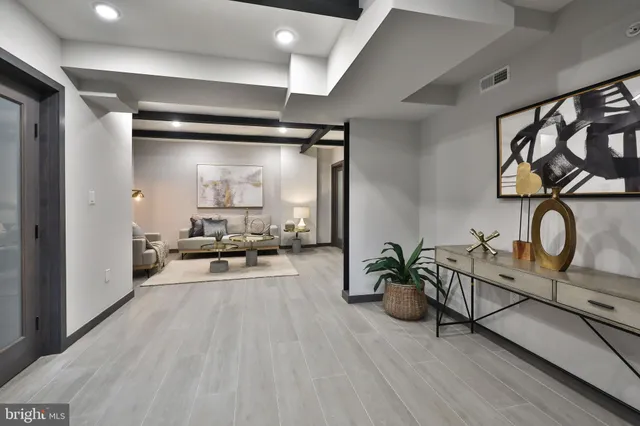 a living room with furniture and wooden floor