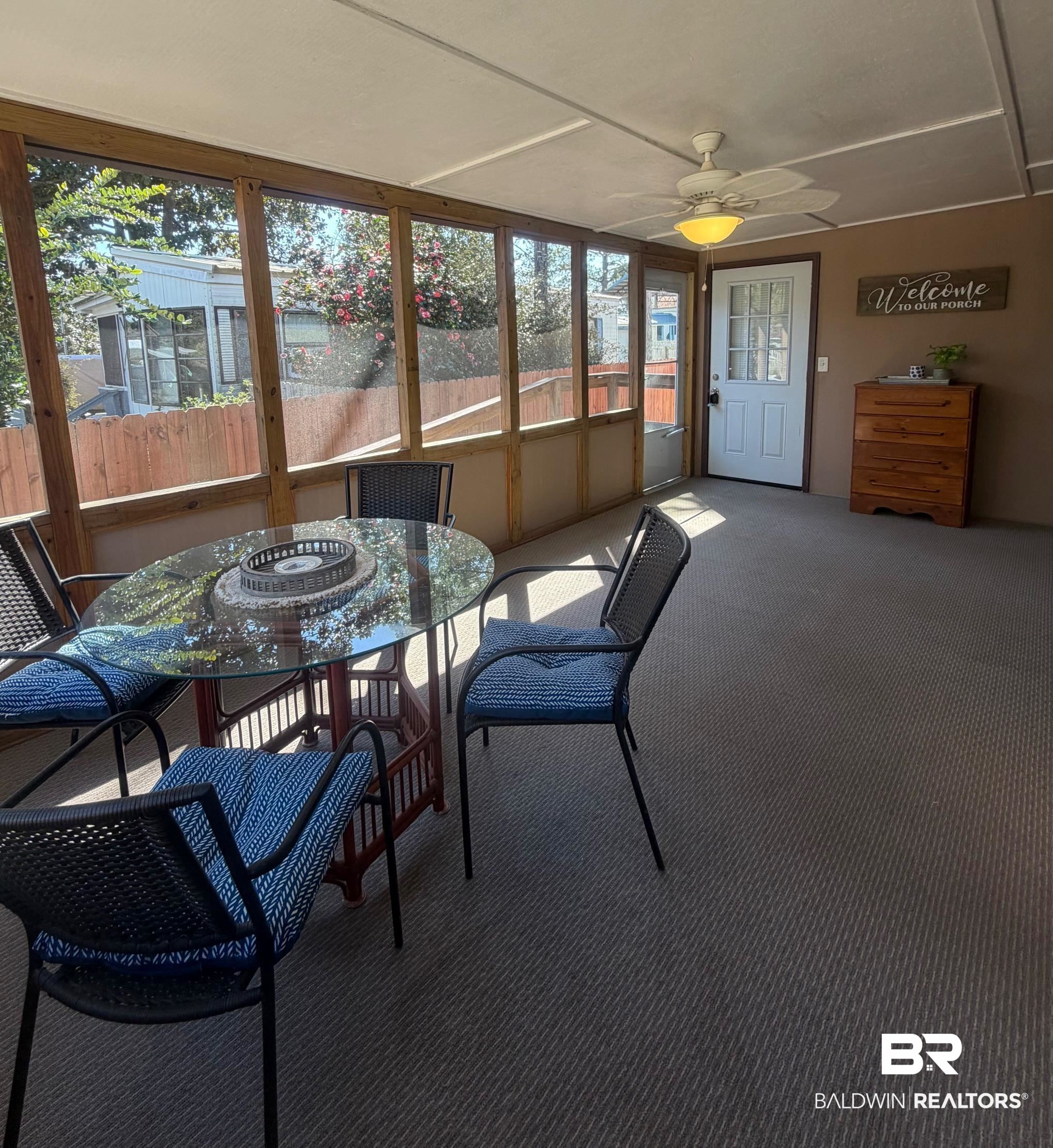 685 Escambia Loop Lillian, AL 36549 - Photo 3 of 43 Sunroom featuring ceiling fan and outdoor dining area