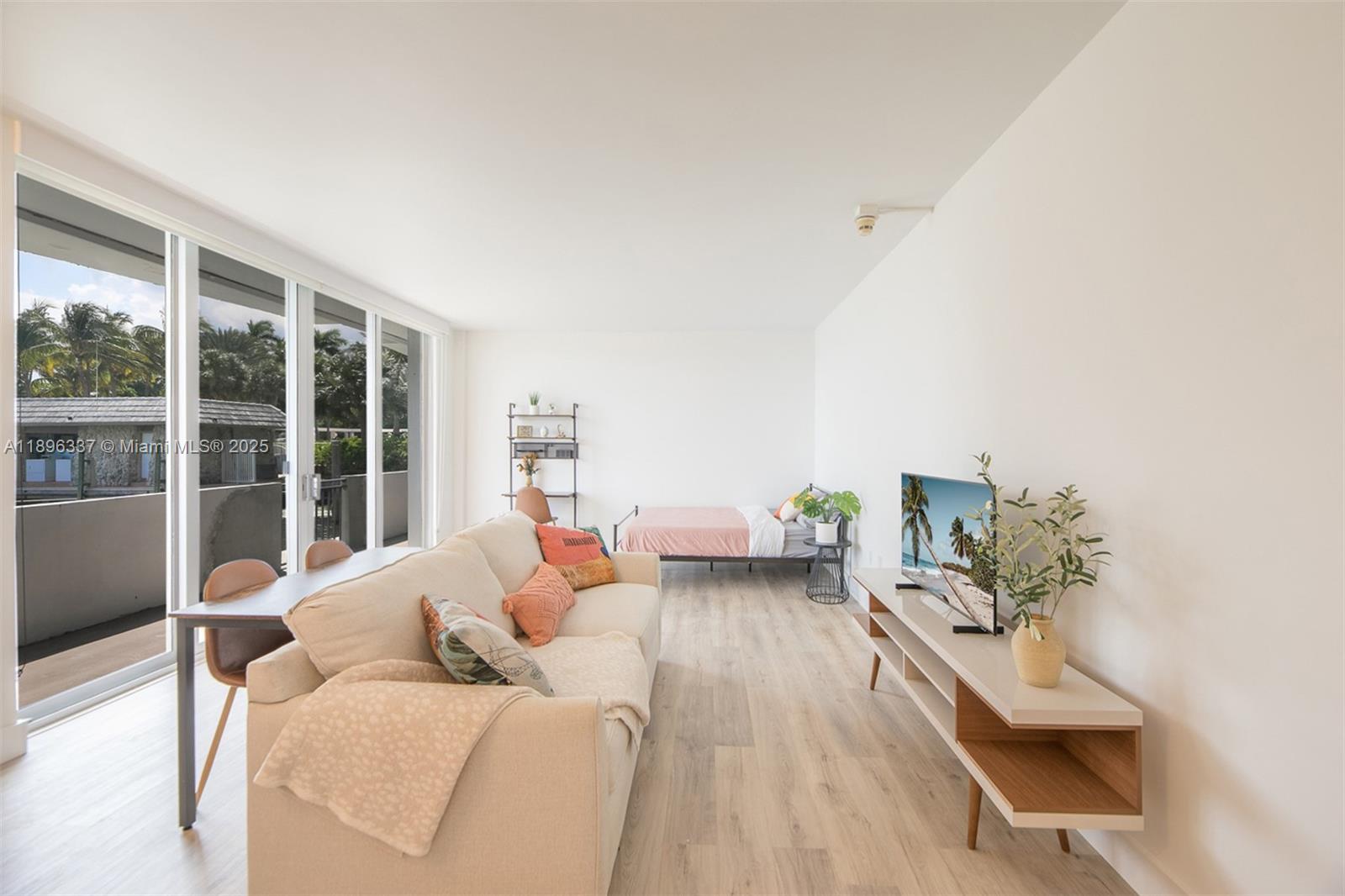 770 Northeast 69th Street, Unit 1B Miami, FL 33138 - Photo 5 of 15 a living room with furniture and a potted plant