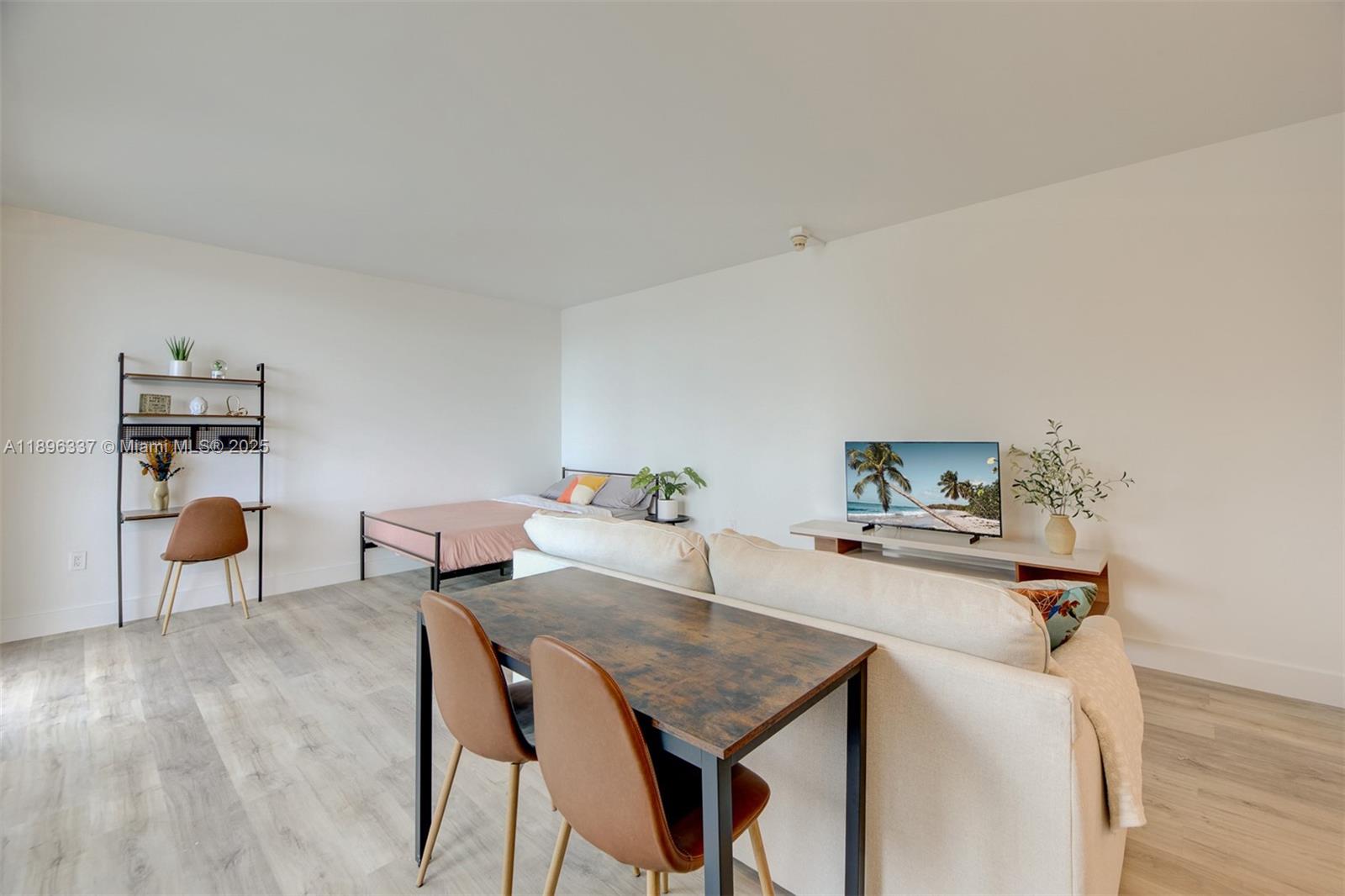 770 Northeast 69th Street, Unit 1B Miami, FL 33138 - Photo 6 of 15 a living room with furniture and wooden floor