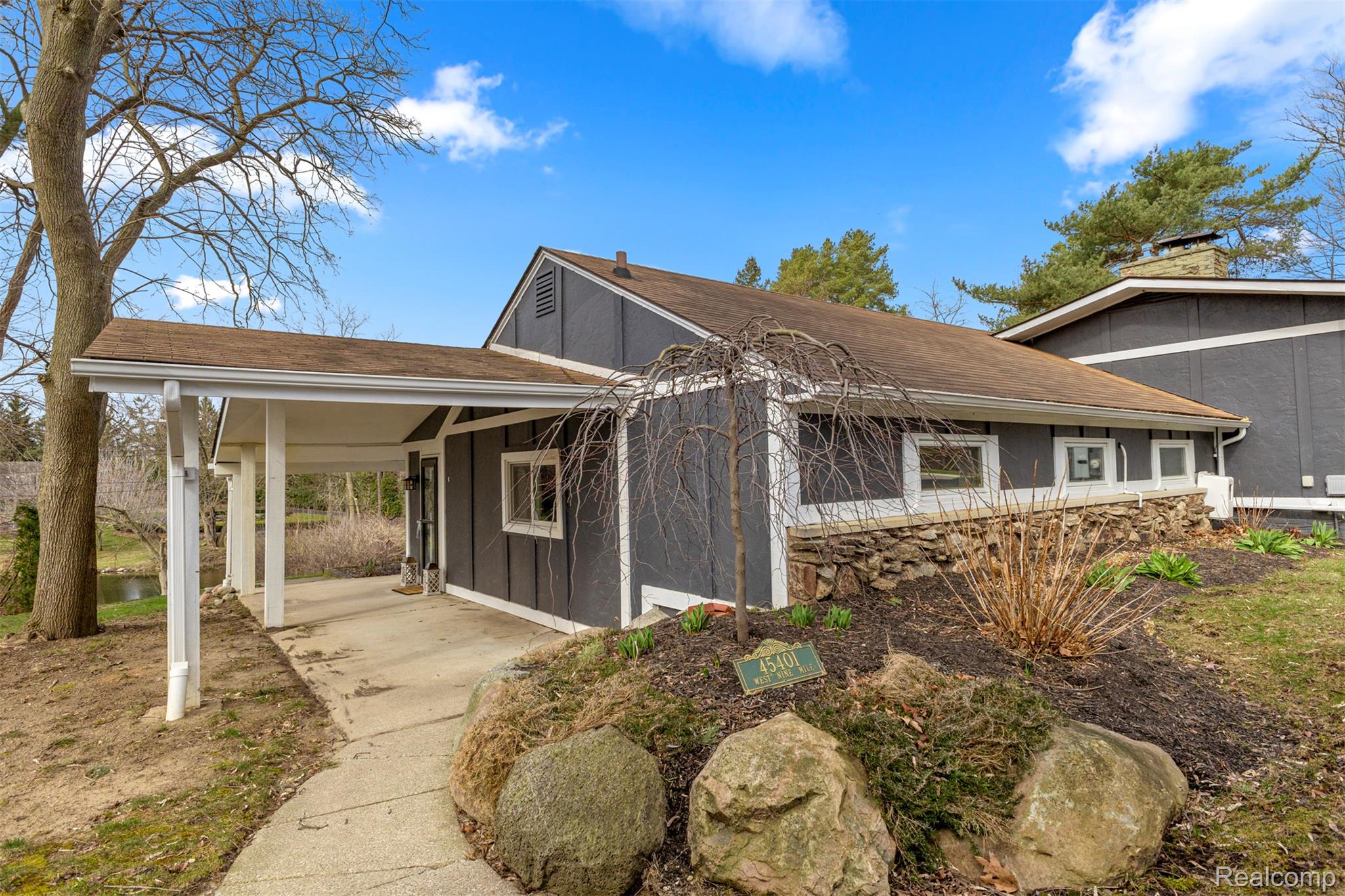 45401 West 9 Mile Road Novi, MI 48374 - Photo 53 of 67 View of property exterior with a shingled roof and a chimney