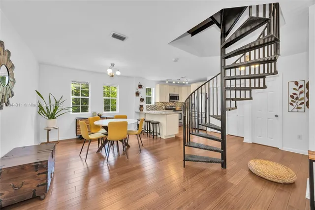 a view of a livingroom with furniture and hardwood floor