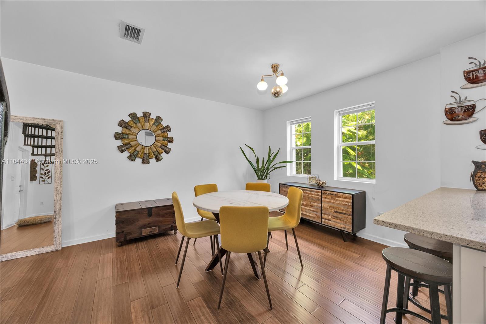 2850 Coconut Avenue, Unit 15 Miami, FL 33133 - Photo 13 of 32 a view of a dining room with furniture window and wooden floor