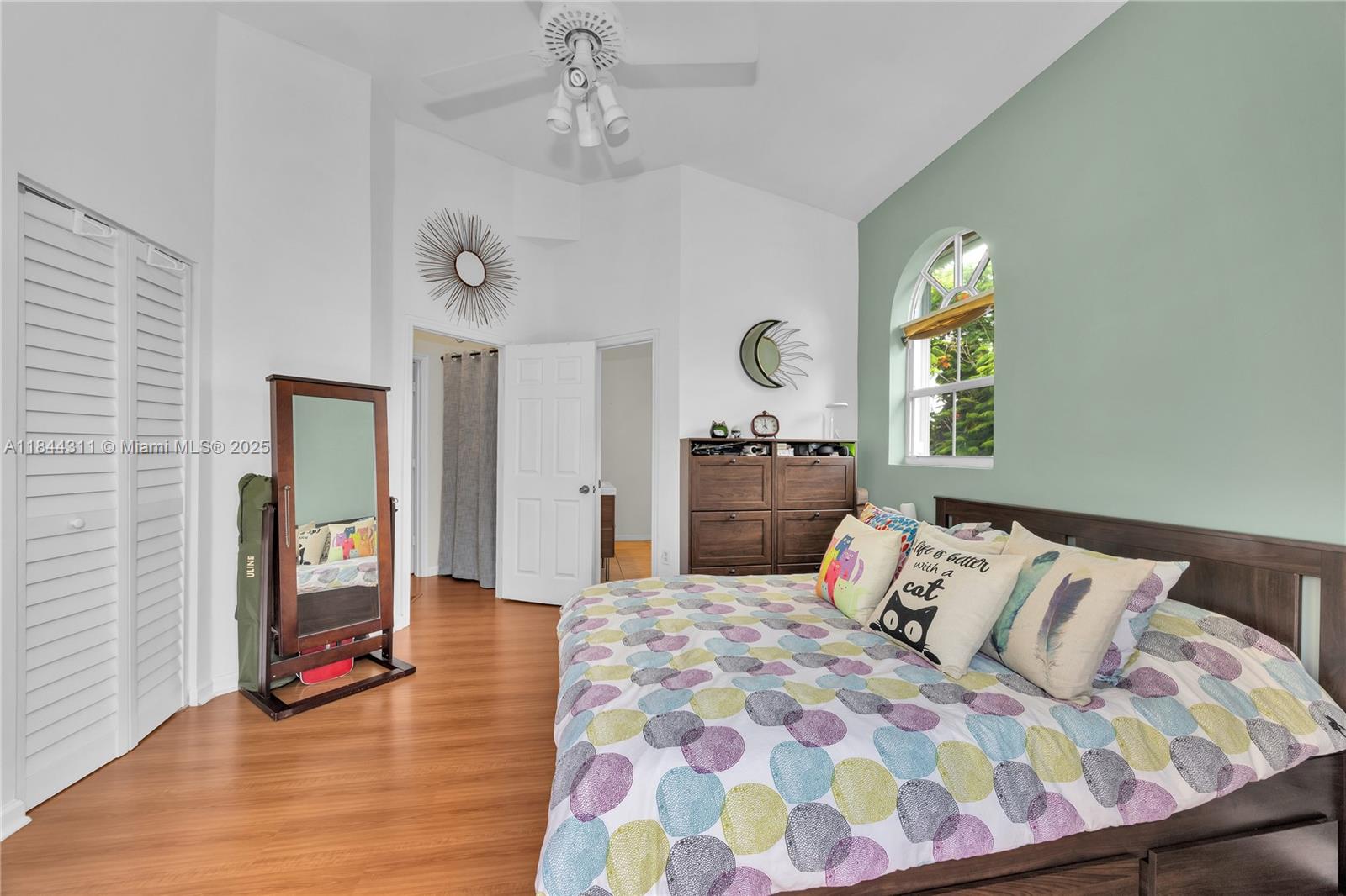 2850 Coconut Avenue, Unit 15 Miami, FL 33133 - Photo 20 of 32 a bedroom with a bed and dresser with mirror