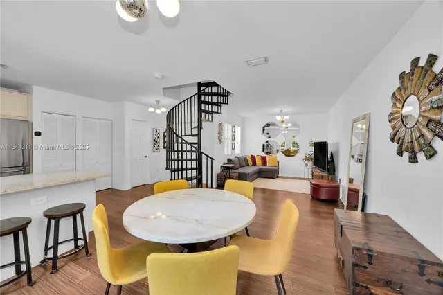 a view of a dining room with furniture and wooden floor