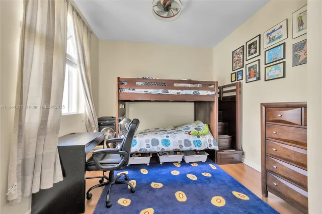 a bedroom with furniture and a wooden floor