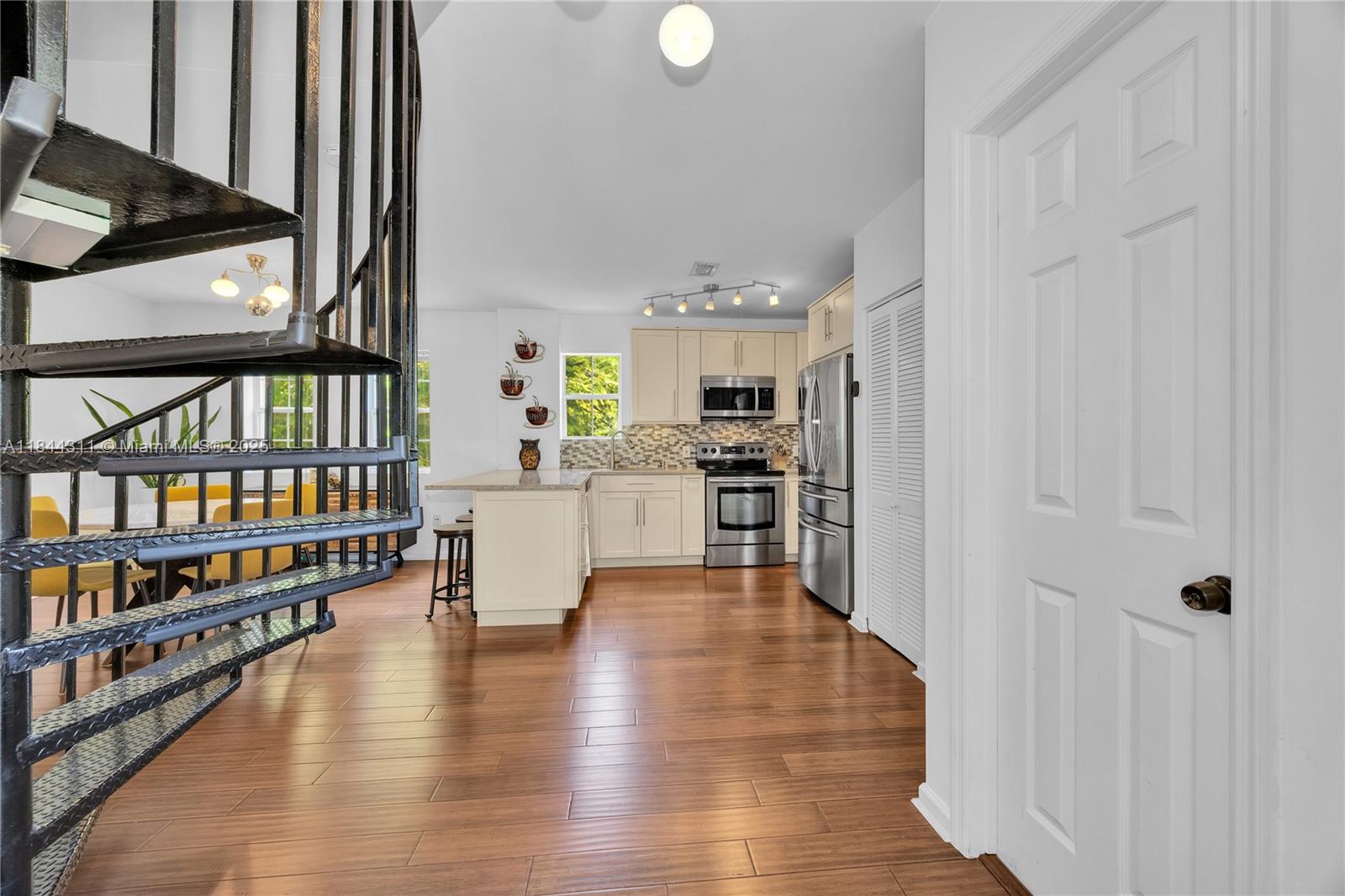 2850 Coconut Avenue, Unit 15 Miami, FL 33133 - Photo 4 of 32 a living room with stainless steel appliances wooden floor and a view of kitchen