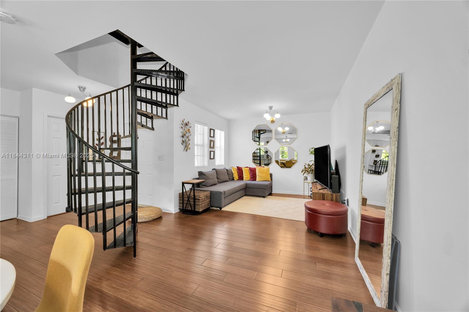 2850 Coconut Avenue, Unit 15 Miami, FL 33133 - Photo 8 of 32 a living room with furniture stairs and a wooden floor