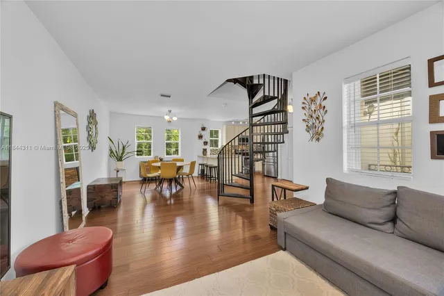 a living room with furniture and wooden floor