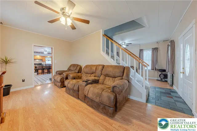 a dining room with furniture a chandelier and wooden floor