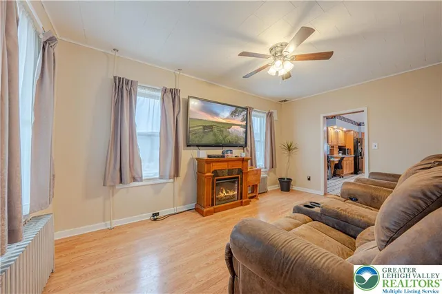 a dining room with stainless steel appliances a dining table and chairs