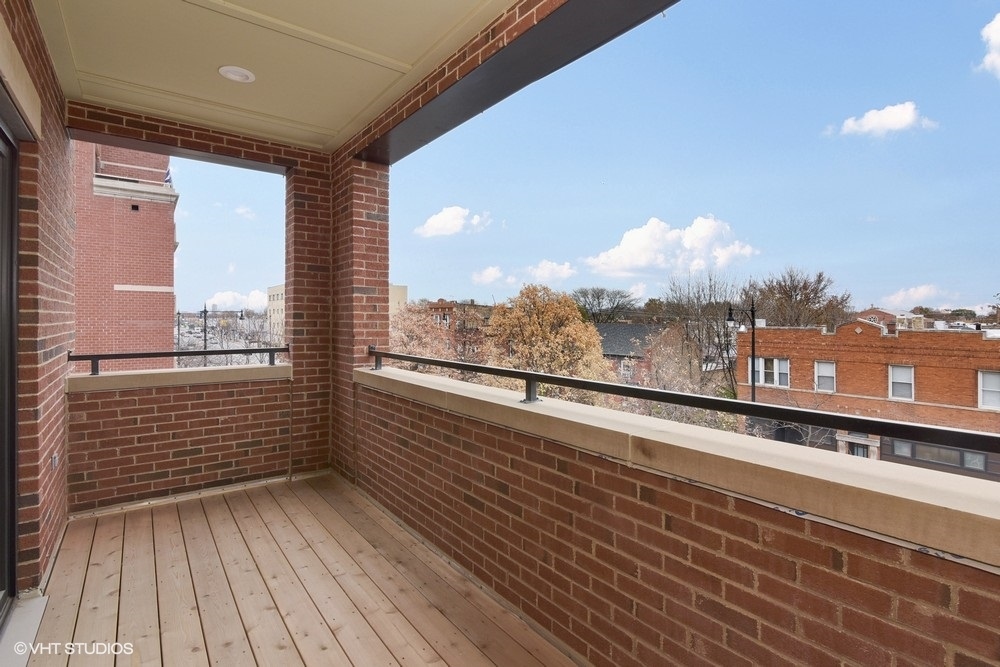 3326 West Irving Park Road, Unit 3E Chicago, IL 60618 - Photo 14 of 15 a view of a balcony with wooden floor